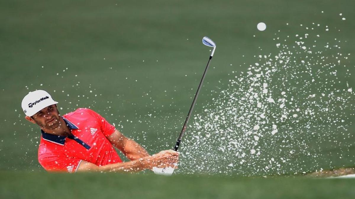 Dustin Johnson chips out of a bunker on the second hole during the final round of the Masters.
