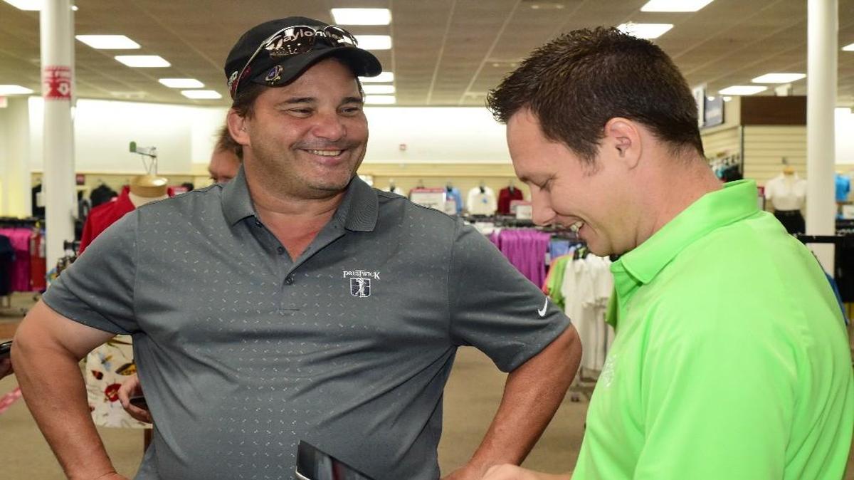 A player registers with tournament director Jeff Monday (right) for the 33rd annual Myrtle Beach World Amateur Handicap Championship on Saturday at PGA Tour Superstore in North Myrtle Beach.
