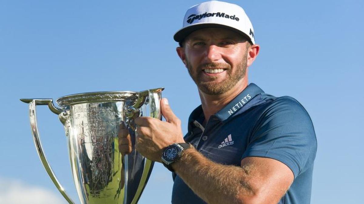 Dustin Johnson holds his trophy after winning the BMW Championship on Sunday.