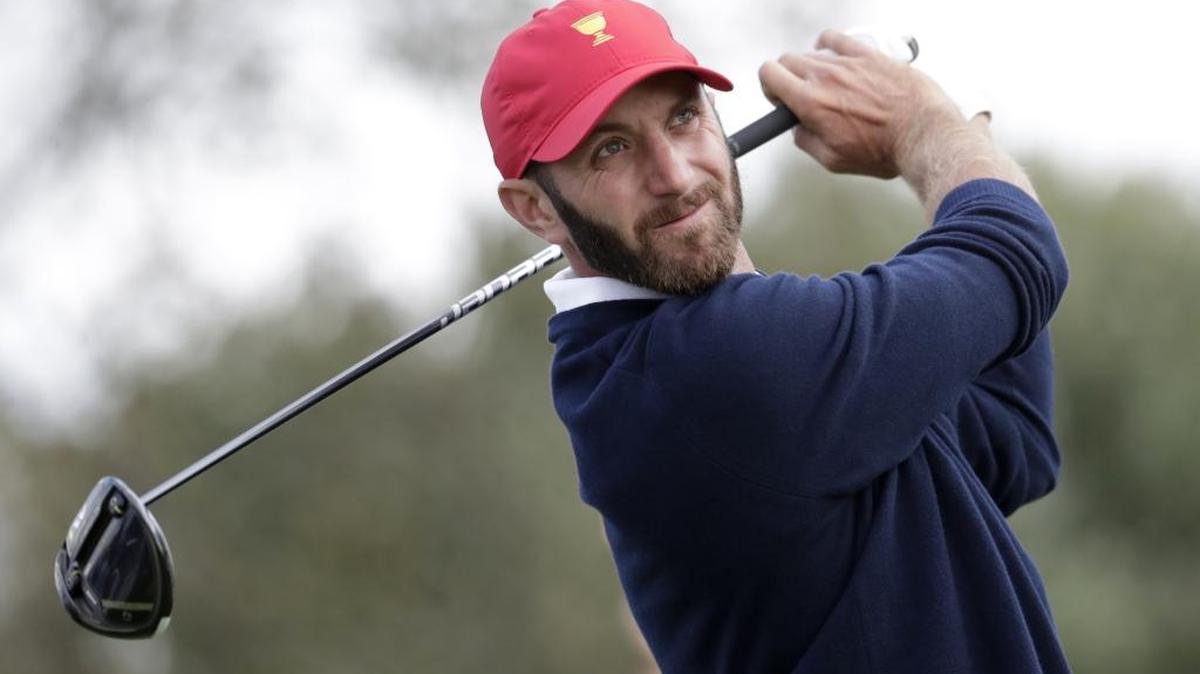 Dustin Johnson of the United States tees off on the 12th hole Saturday during the third day of the Presidents Cup at Liberty National Golf Club in Jersey City, N.J.