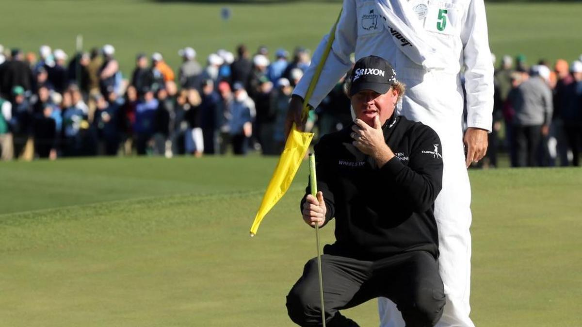 William McGirt and his caddie, Brandon Antus, line up his birdie attempt on the seventh green Friday.