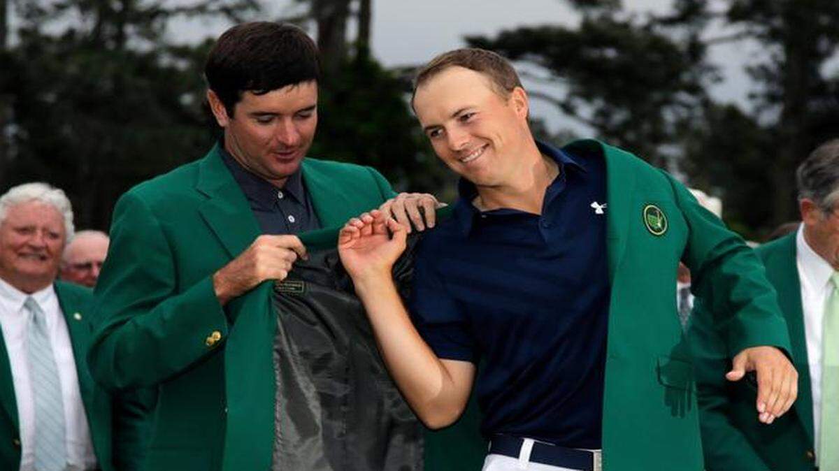 
Bubba Watson helps 2015 Masters winner Jordan Spieth put on his green jacket after Sunday’s final round.

