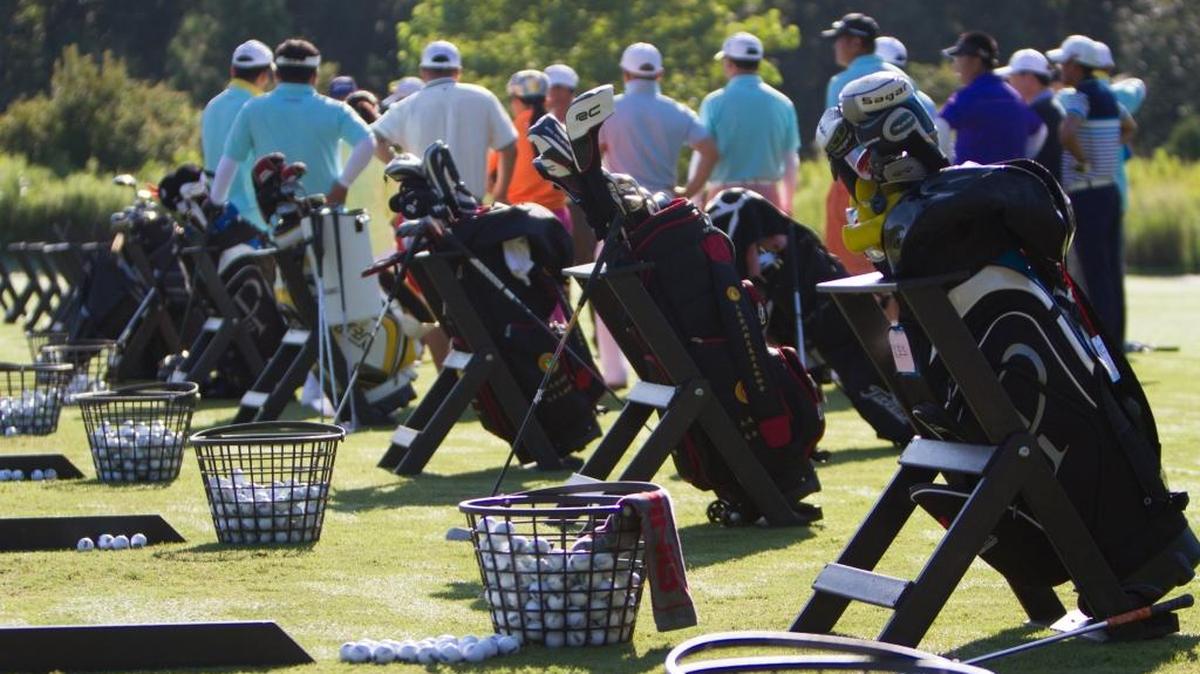 Golf bags are lined up on a range at Grande Dunes.
