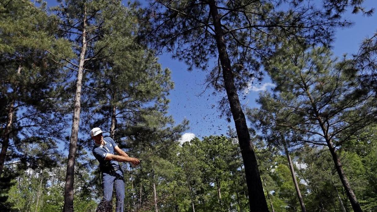 Dustin Johnson hits out of the rough on the 11th hole during the second round of the Masters golf tournament on Friday.