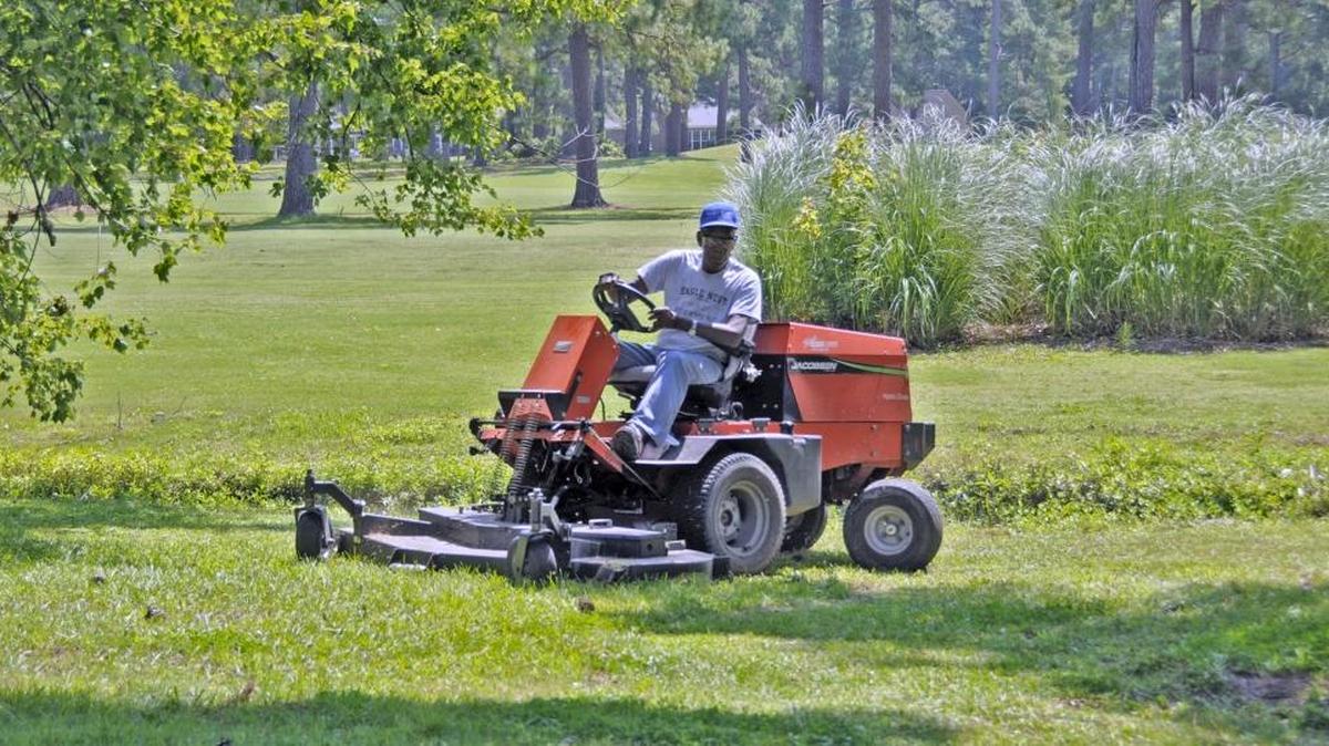Bill DeWitt, the Myrtle Beach Area Golf Course Owners Association 2014 Employee of the Year, cuts grass at Eagle Nest Golf Club in Little River.
