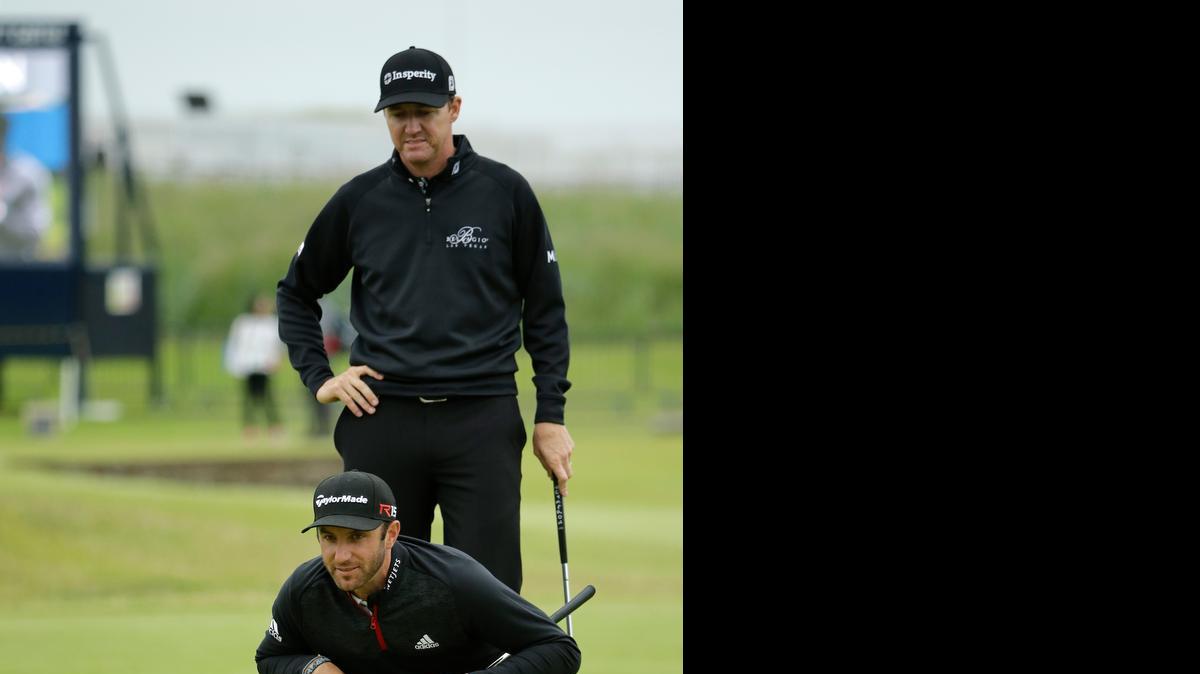 
Dustin Johnson (front) and United States’ Jimmy Walker prepare to putt on the 17th green during a practice round for the British Open at the Old Course, St. Andrews, Scotland.
