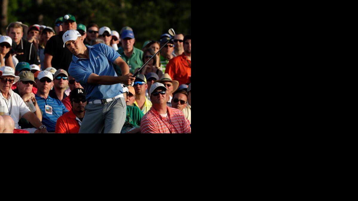 
Jordan Spieth hits out of the gallery on the 18th hole during the third round of the Masters on Saturday in Augusta, Ga. 
