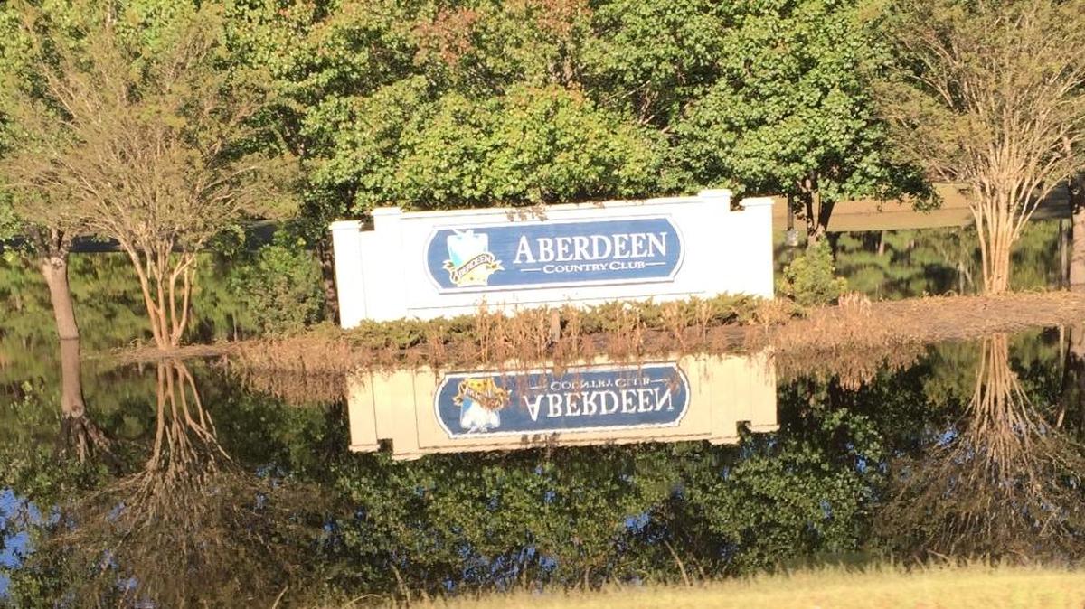 The sign for Aberdeen Country Club is an island in flood waters on Oct. 20. The course is reopening Friday.