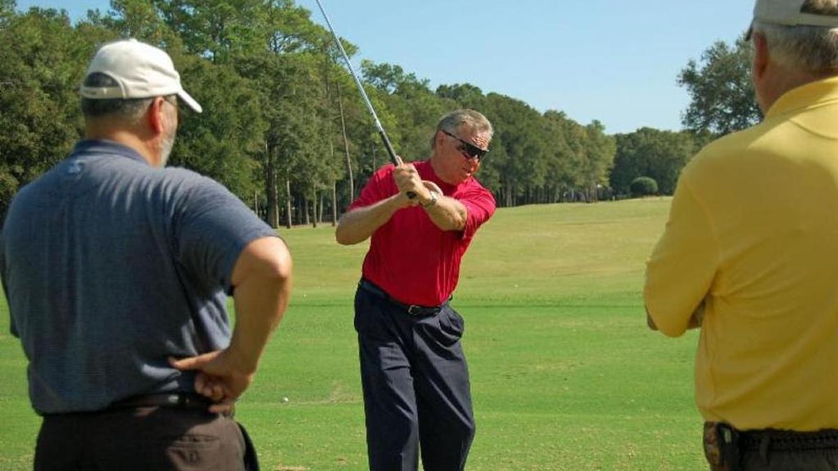 Mel Sole (center) offers instruction at one of his golf schools. Sole is celebrating 50 years as a golf instructor