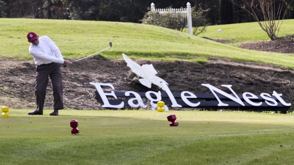 A golfer tees off on the 18th hole at Eagle Nest Golf Club in Little River.