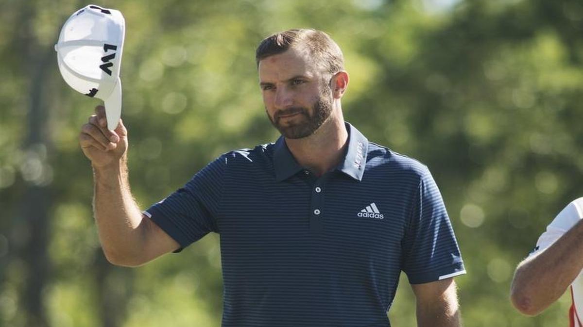 Dustin Johnson tips his hat to the fans after making a birdie on the 18th hole to take the lead Sunday at the Wells Fargo Championship at Eagle Point Golf Club in Wilmington, N.C.