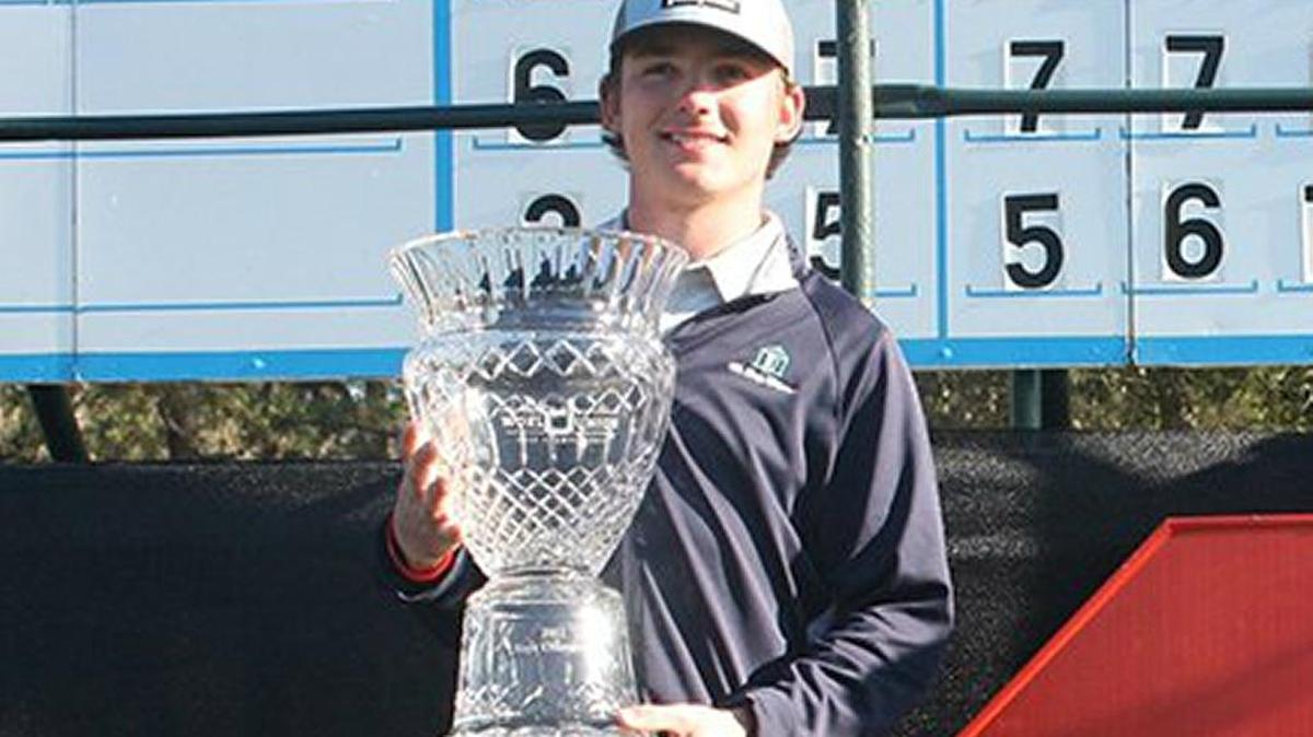 Trent Phillips of Inman, left, pictured holding the trophy from the 2017 Dustin Johnson World Junior Championship, won the S.C. Junior on Thursday.
