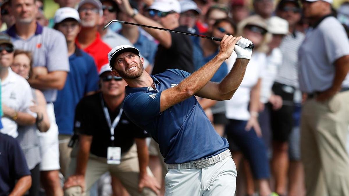 Dustin Johnson watches his shot from the rough on the fifth fairway during the final round of the Tour Championship.
