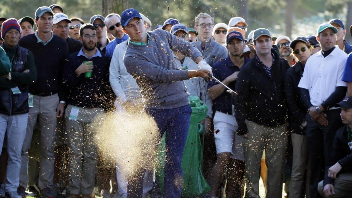 Jordan Spieth hits out of the rough off the 17th fairway en route to making a bogey during the third round of the Masters on Saturday.