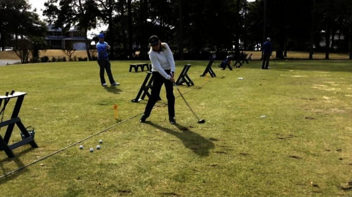 Mo Spada hits a ball on the driving range of Lockwood Folly Country Club in January 2016.