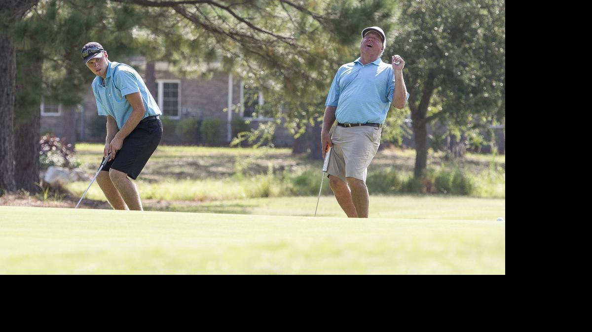 
Bryan Kendrick reacts to his son Bryce's missed put for an eagle during the final final round of the 18th National Father & Son Team Classic at The Thistle. The Kendrick team ultimately birdied the hole and went on to win the tournament. 
