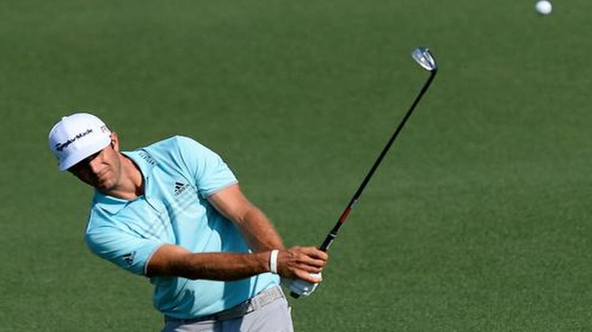 
Dustin Johnson chips his ball onto the second green during first round action of the Masters at Augusta National Golf Club.
