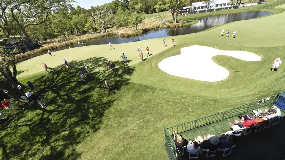Players walk up to the 18th green at Eagle Point Golf Club during the Wells Fargo Championship Pro-Am on Wednesday.