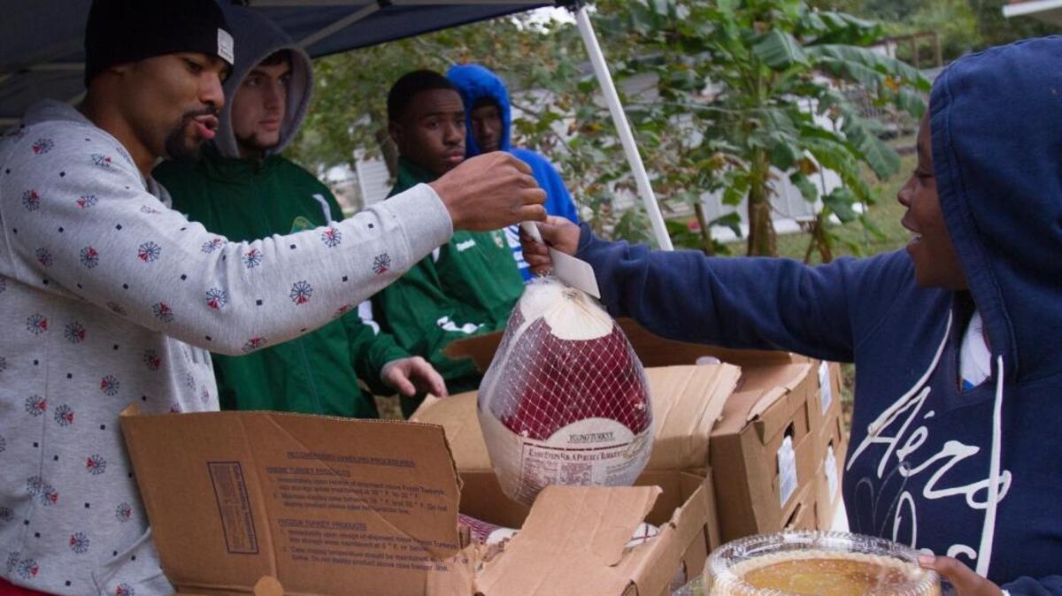 NBA player Ramon Sessions hands out turkeys and other fixings during his annual Thanksgiving event in the Racepath community last November.
