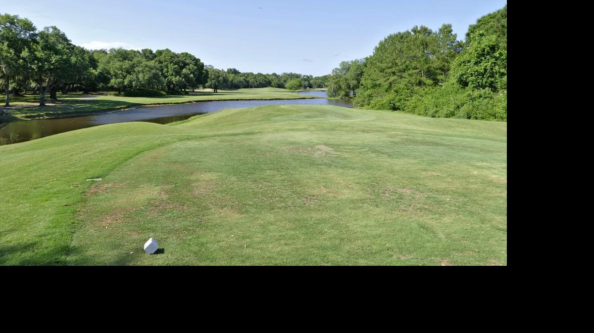 Looking from the white tees, the par-4 fifth hole at Willbrook Plantation Golf Club has a peninsula fairway with water in front, to the right and behind it fronting the green.