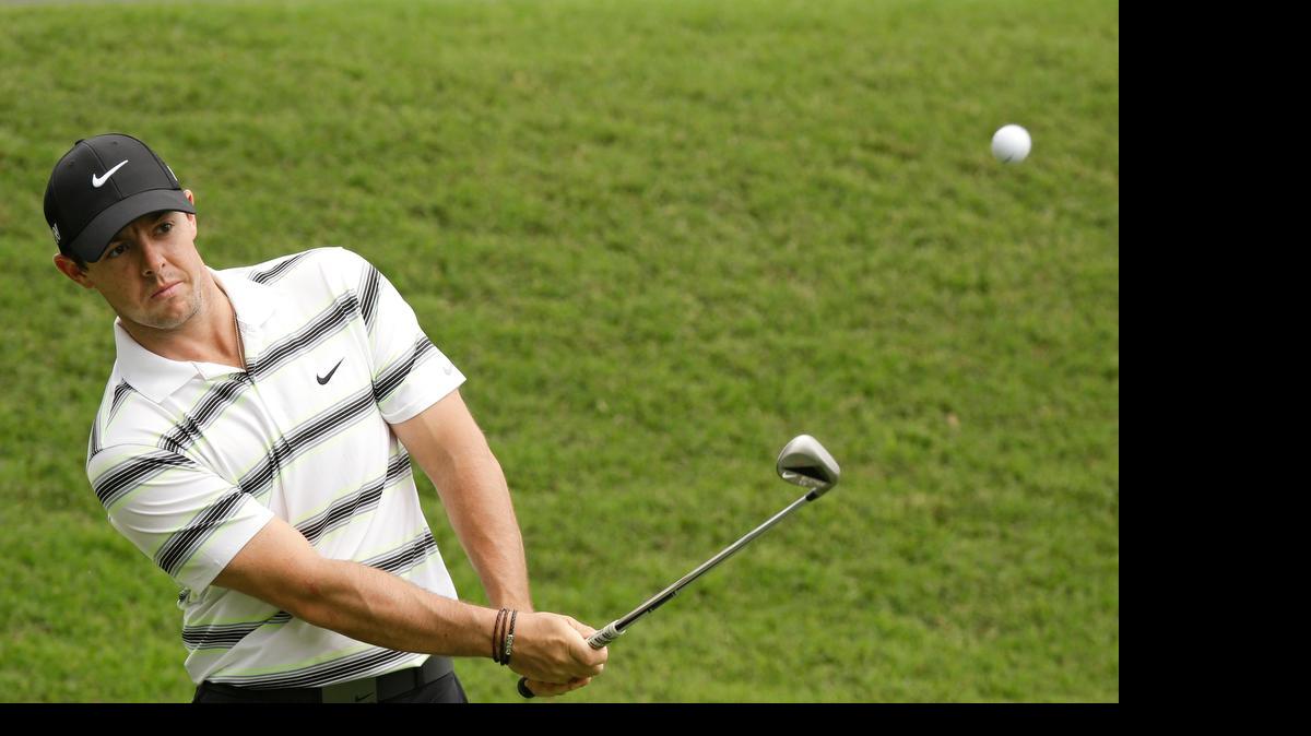 
Rory McIlroy chips a shot to the green on the first hole during Wednesday’s practice round for The Players Championship.

