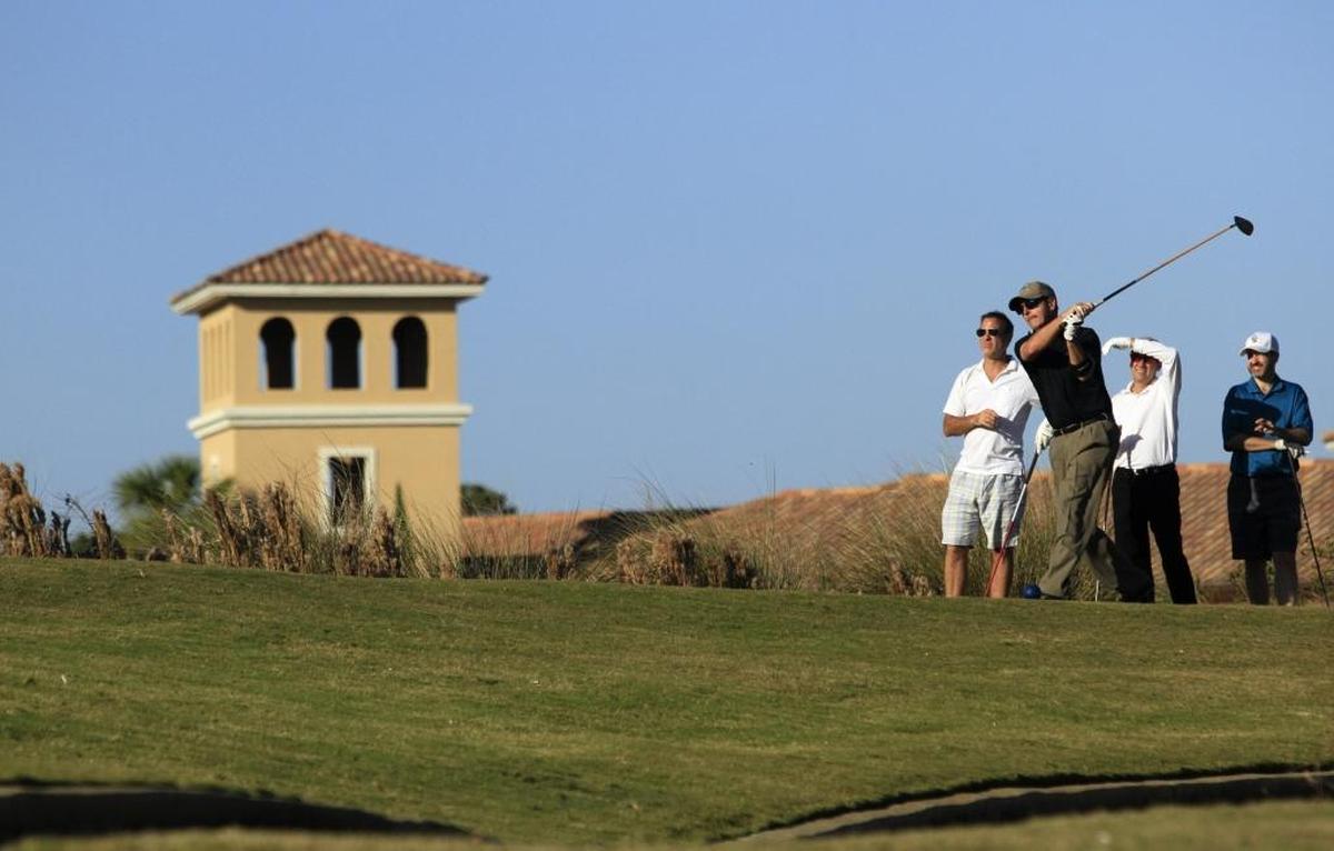 A golfer tees off at the Grande Dunes Resort Course.