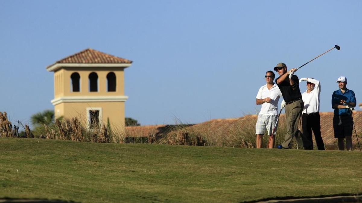 A golfer tees off at the Grande Dunes Resort Course. 