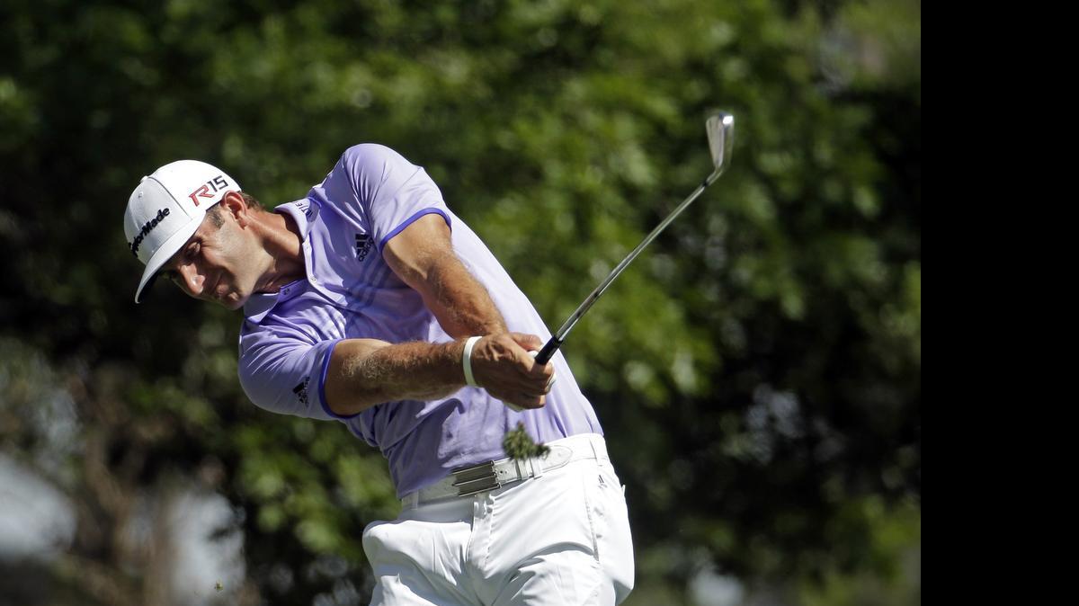 
Dustin Johnson tees off on the fourth hole during the third round of the Masters golf tournament April 11 in Augusta, Ga. 
