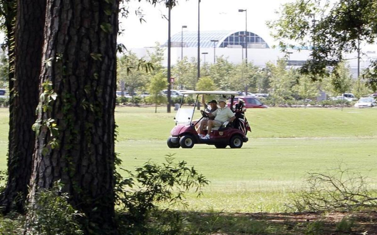 Golfers play at Whispering Pines Golf Course in 2014.