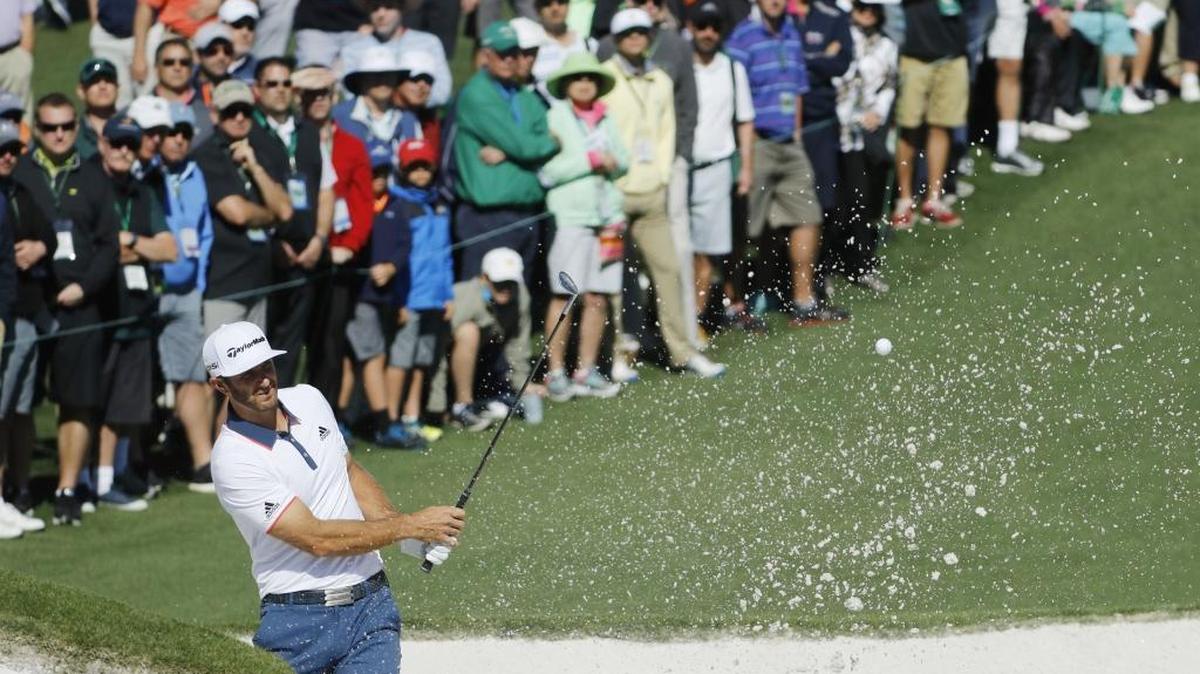 Dustin Johnson chips out of a bunker on the second hole during the first round of the Masters on Thursday.