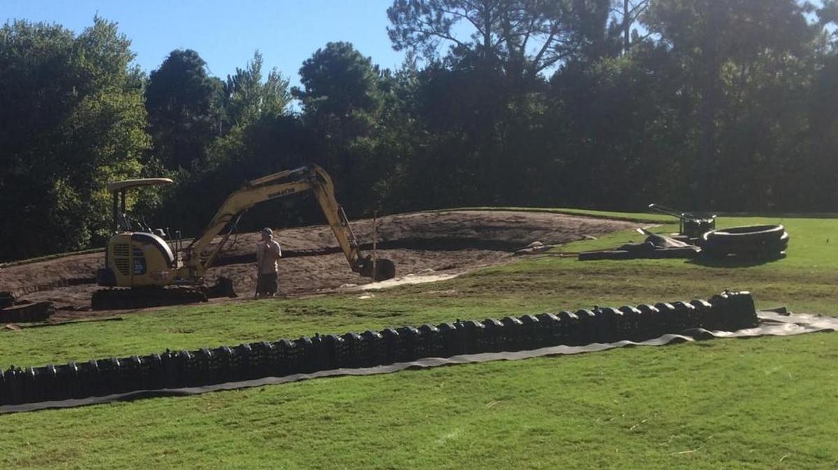 
Workers dig a trench in order to place a chamber system drain pipe in a bunker at Sandpiper Bay Golf & Country Club.
