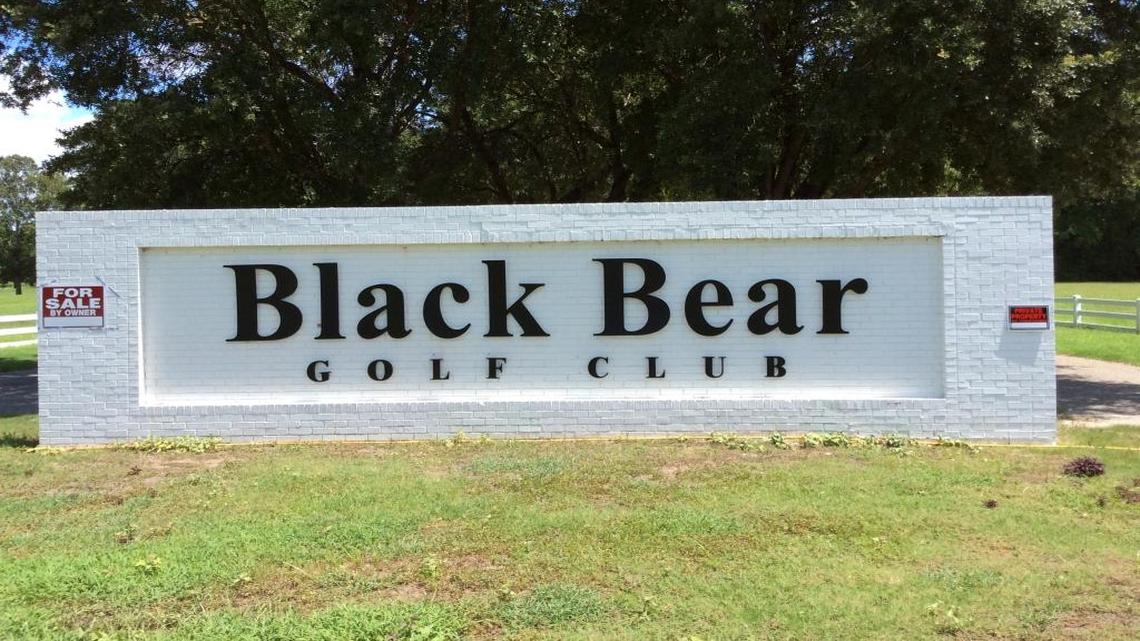 For Sale and No Trespassing signs adorn the entrance sign of Black Bear Golf Club after the course closed in August 2016.