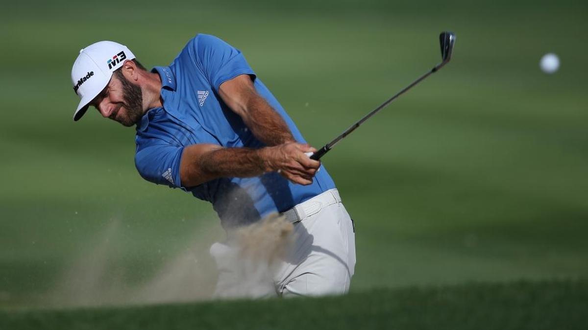 Coastal Carolina alumnus Dustin Johnson plays a bunker on the 10th hole during a pro-am Wednesday in advance of the Abu Dhabi Championship golf tournament in Abu Dhabi, United Arab Emirates.