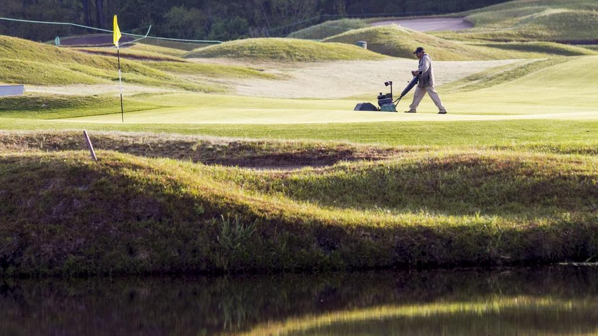 A golf course maintenance worker makes final preparations for the 23rd Hootie & the Blowfish Monday After the Masters Celebrity Pro-Am on April 10, 2017 at Barefoot Resort’s Dye Club.