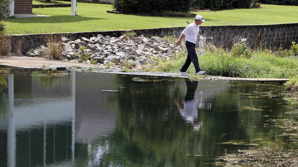 Ryan Martin of Pretonsburg, Kentucky, crosses water off the 17th hole at River Hills Golf & Country Club in Little River on Friday, Aug. 7, 2015.