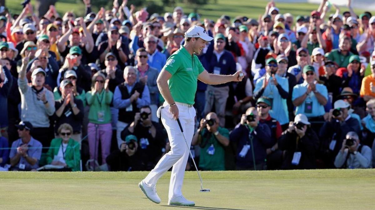 Danny Willett, of England, celebrates on the 18th hole after finishing the final round of the Masters.