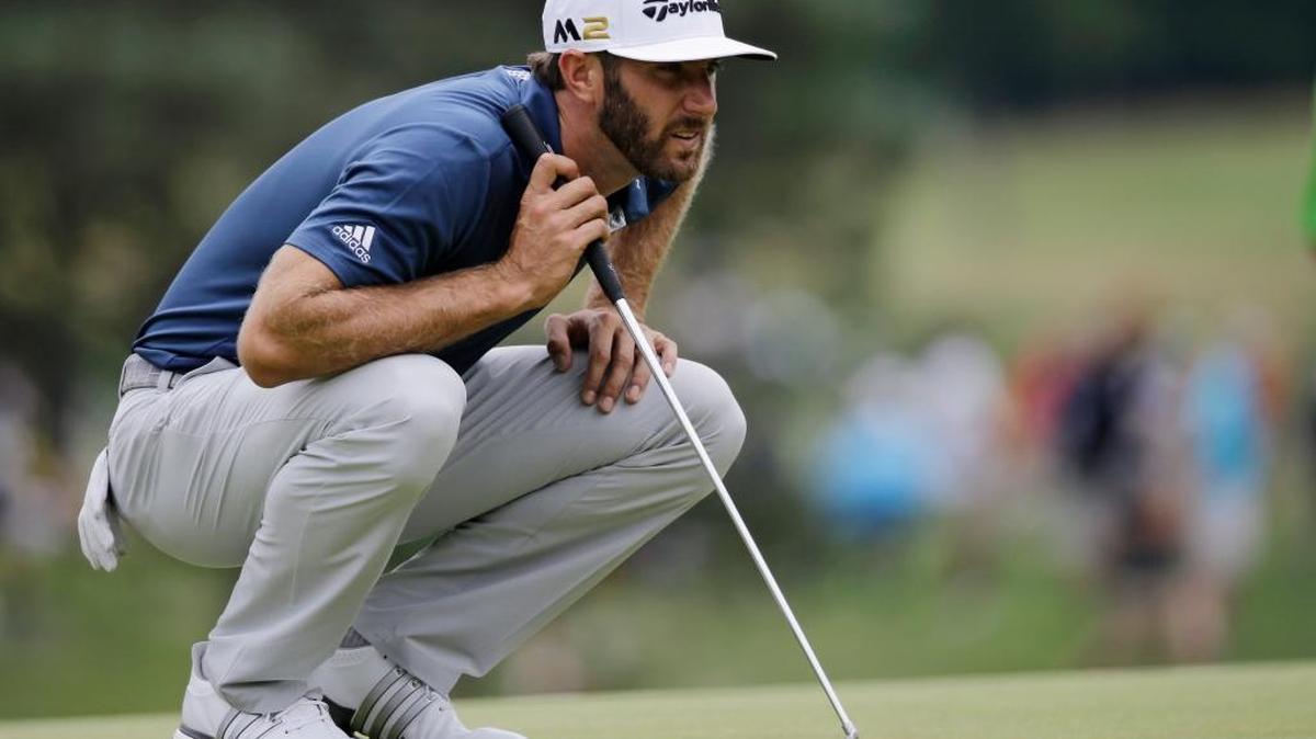 Dustin Johnson lines up a putt on the first hole during the final round of the Bridgestone Invitational at Firestone Country Club on Sunday.