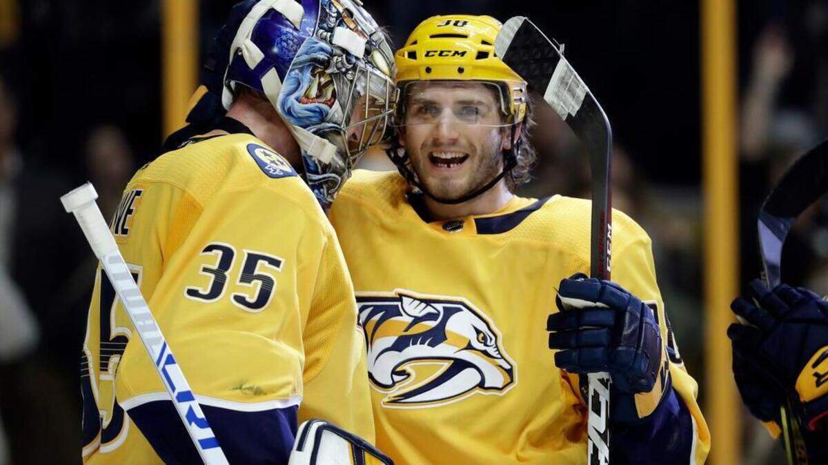 FILE - In this March 8, 2018, file photo, Nashville Predators goalie Pekka Rinne (35), of Finland, celebrates with right wing Ryan Hartman (38) after beating the Anaheim Ducks in an NHL hockey game in Nashville, Tenn. Hartman was a trade-deadline addition who's making an impact. (AP Photo/Mark Humphrey, File)