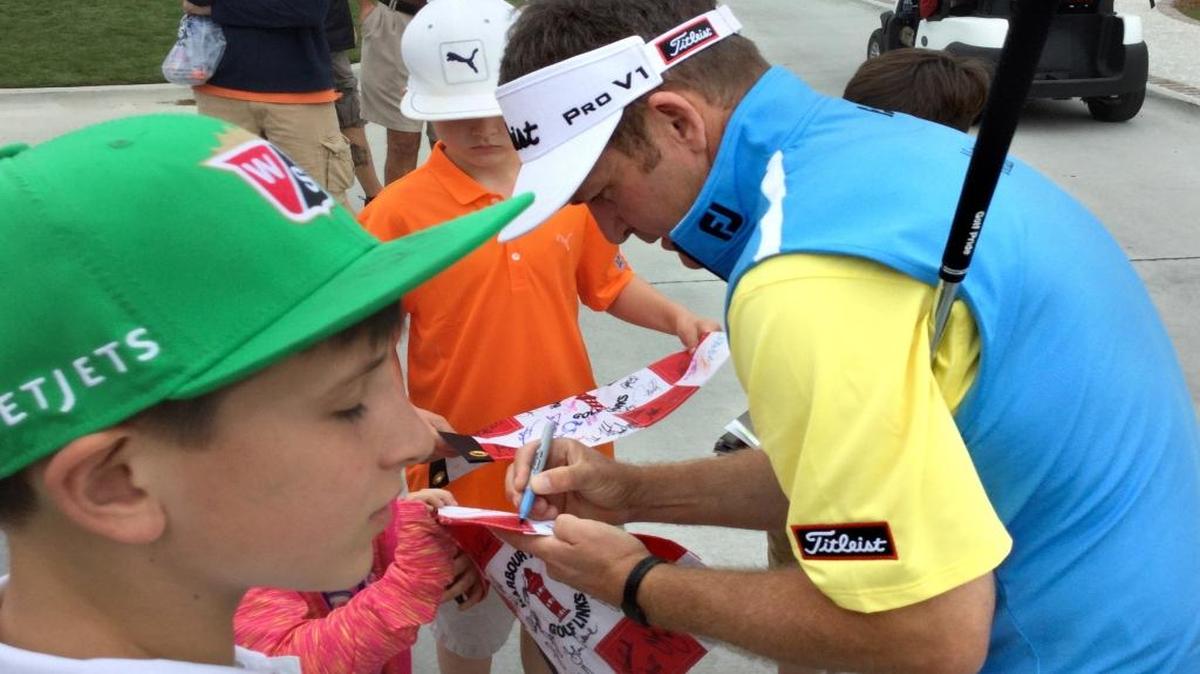 Jason Bohn signs autographs Tuesday near the putting green at Harbour Town Golf Links.