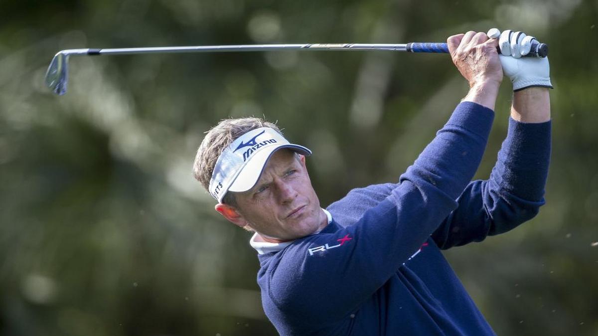 Luke Donald, of England, watches his shot on the 10th tee during the first round of the RBC Heritage golf tournament in Hilton Head Island.
