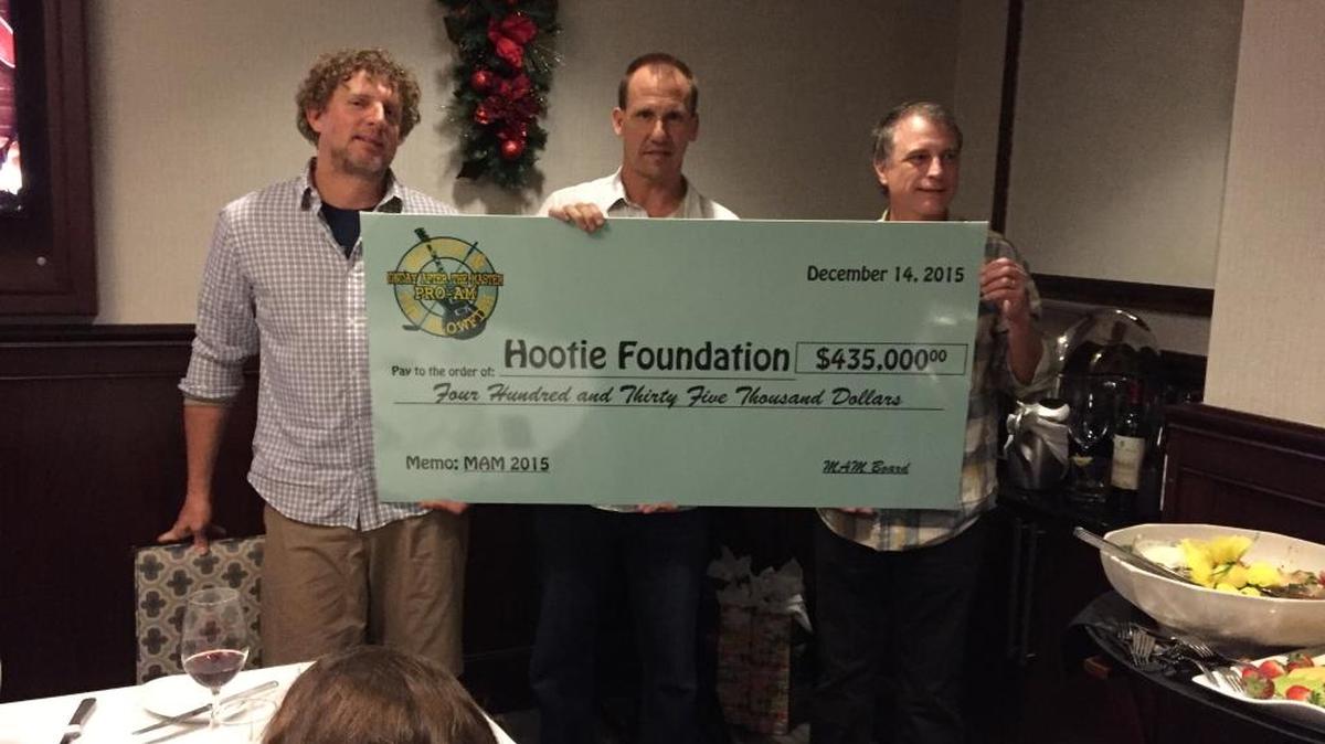 Band members (left to right) Mark Bryan and Jim Sonefield and band business manager Chris Carney present a check at a dinner Monday night in Columbia.