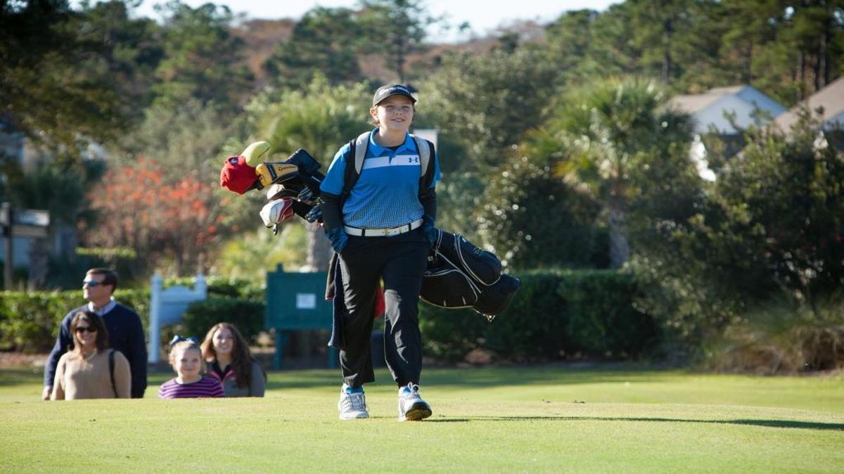 Twelve-year-old Walker Devers makes his way up the hill toward the Dutin Johnson Golf School at TPC of Myrtle Beach in November 2015.