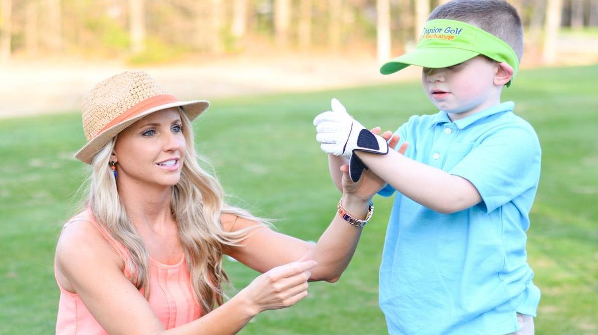 
Meredith Kirk works with a junior golfer during a club giveaway in April at Blackmoor Golf Club.
