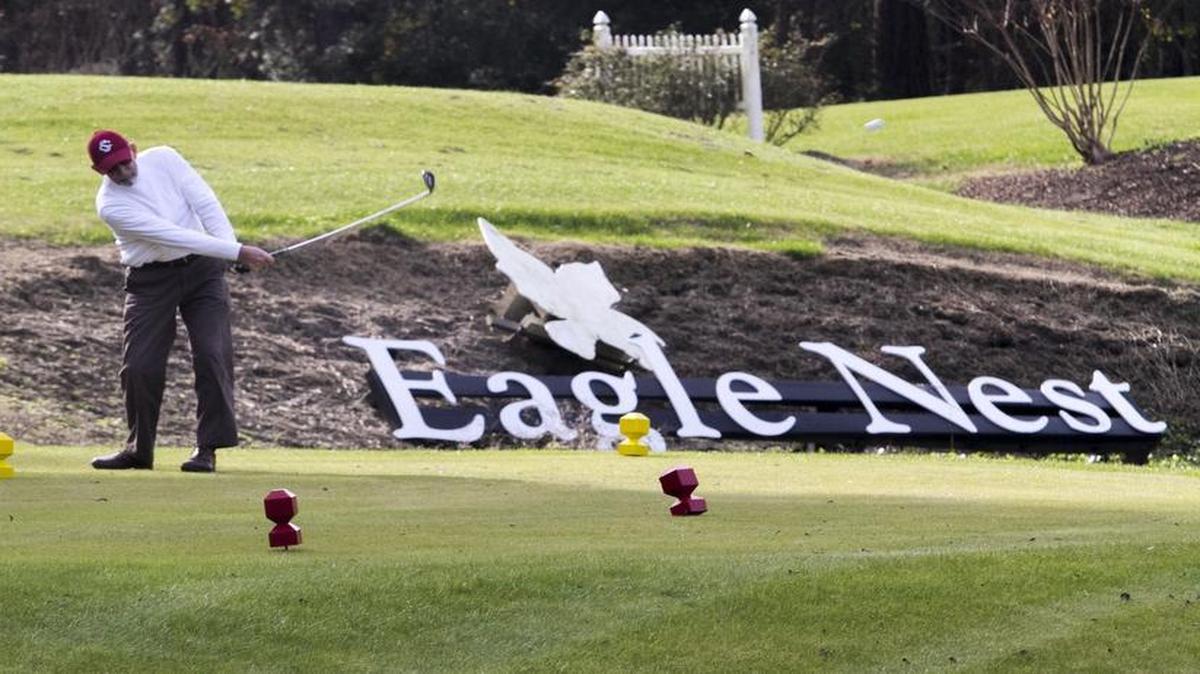 A golfer tees off on the 18th hole at Eagle Nest in Little River.