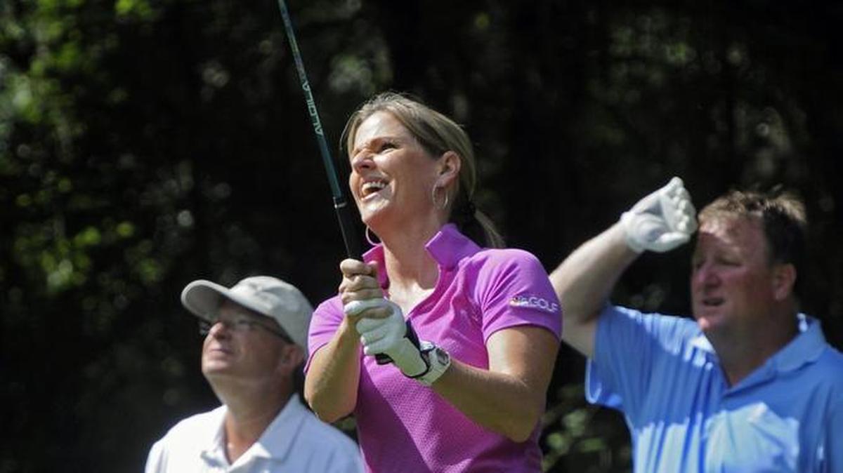 Former Golf Channel personality Kelly Tilghman (center) of North Myrtle Beach hits a shot during the 2015 First Tee of the Grand Strand Future Generations Tournament at Caledonia Golf & Fish Club.