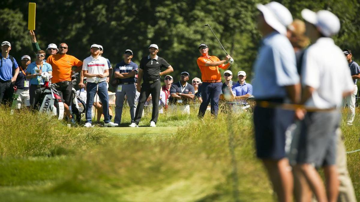 Sebastian Soderberg (left), swing instructor Claude Harmon and Dustin Johnson watch as Peter Hanson hits his tee shot on the eighth hole during a practice round Monday for the U.S. Open at Oakmont Country Club.