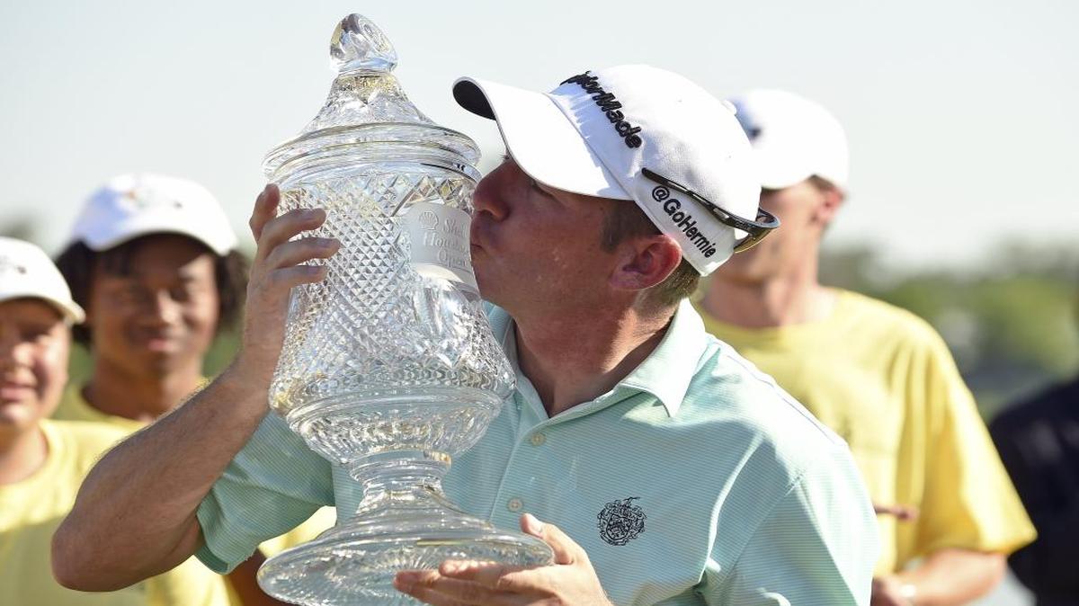 Jim Herman kisses the winner’s trophy after winning the Houston Open golf tournament this past Sunday. Herman was forced to change his plans after winning the tournament, earning a spot in this year’s Masters.
