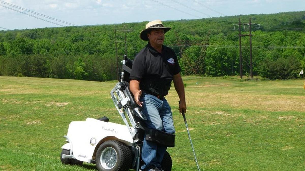 Stand Up and Play Foundation founder Anthony Netto demonstrates use of a ParaGolfer cart at a 2015 clinic.