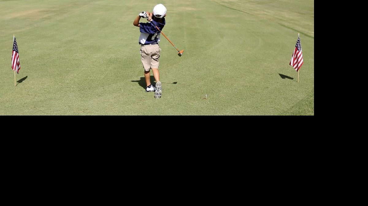 
Campbell McClain tees off between the flags in the PGA Junior League Golf at Wachesaw Plantation Club on Thursday, July 2, 2015. He's part of the River Oaks Bears and they are in a nine-hole match with the Wachesaw Warriors. The junior league is designed to make golf more of a social event for boys and girls ages 13 and under. It features team competitions in a scramble format as opposed to individual stroke-play competition. The program that was founded and is supported by the PGA of America.
