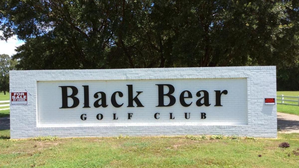 “For Sale” and “No Trespassing” signs adorn the brick entrance sign Thursday at Black Bear Golf Club in Longs.